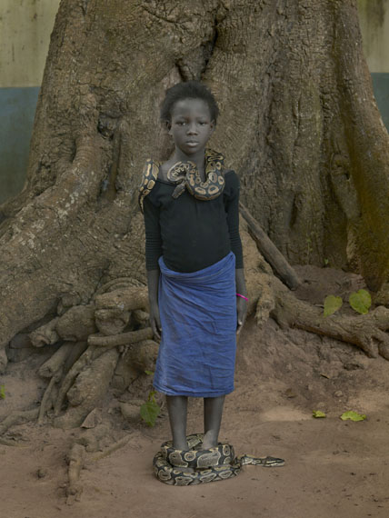 Nahaume Ouielle, 8 ans, with Daba Dre Snakes, Temple Des Pythons, Ouidah, Benin, 2011 © Albert Watson