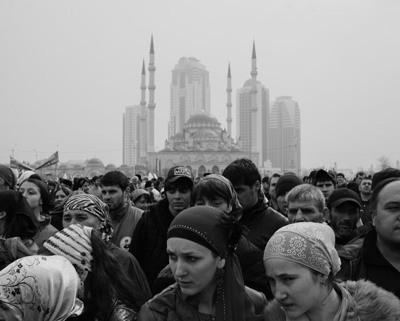 Republic of Chechnya, Russia, 03/2013. A group of pro-Kadyrov activists in the city’s main square celebrating the 10th Constitution Day. In the background are the Central Mosque and the Grozny City skyscrapers, the main symbol of the reconstruction of Grozny and Chechnya thanks to the efforts of President Kadyrov and the money provided by Moscow. Grozny.g to transform it into one of the region’s main tourist destinations. Karachoi. © Davide Monteleone /VII for Carmignac Gestion Photojournalism Award