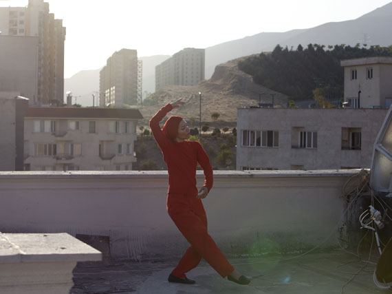 A female performer practicing on a roof overlooking the capital, Tehran has a vibrant theatre scene, which many use as a way to criticize society. © Newsha Tavakolian