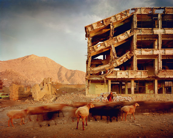 Simon Norfolk: Bullet-scarred apartment building and shops in the Karte Char district of Kabul. This area saw fighting between Hikmetyar and Rabbani and then between Rabbani and the Hazaras, 2003 © Simon Norfolk