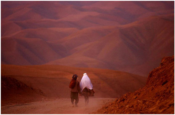 A couple went down the barren roads of Badakhshan province, North Afghanistan, 2001 © James Hill