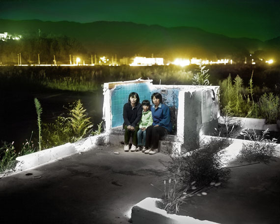 Three Generations. Tomoko Hida, Sana Hida & Yoshimi Hida (mother, daughter and grandmother) pose in the remains of their home one and half years after it was destroyed by the tsunami. © Alejandro Chaskielberg.