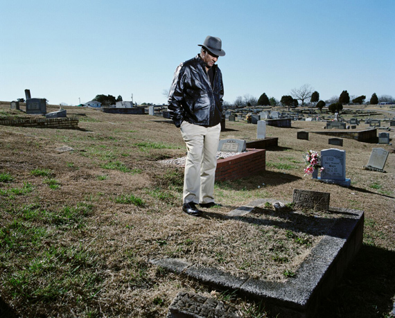 EDGEMONT CEMETERY, WEST ANNISTON, ALABAMA, 2012 © Mathieu AsselinDavid Baker (65) at his brother Terry's grave. Terry Baker died at the age of 16 from a brain tumor and lung cancer, caused by PBC exposure. The average level of PBC in Anniston is twenty-seven times higher than the national average.