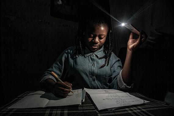 Goma, Democratic Republic of Congo, April 27-28, 2020. With schools closed during Congo’s period of confinement, and the city implementing regular power cuts, my 13-year-old sister Marie studies at home by the light of a mobile phone. 
© Arlette Bashizi for Fondation Carmignac