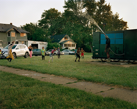 Kunstverein in HamburgLaToya Ruby Frazier, Shea Cobb, Amber Hasan, and Her Children, Nieces, and Nephews (Zari, DJ, Jayda, Justin, Justace, Jaylen) and Their Friends Playing in the Water Moses West Is Spraying from His Atmospheric Water Generator on North Saginaw Street Between East Marengo Avenue and East Pulaski Avenue, Flint, Michigan, 2019 © LaToya Ruby Frazier. Courtesy of the artist and Gladstone Gallery.