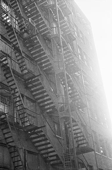Walter SchelsFire Escape, New York, 1962Gelatin Silver Print on expired Ilford Baryta paper (2023)38 x 27 cm, unique