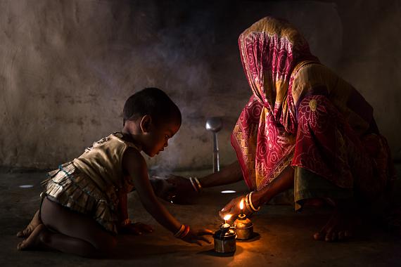 Brent Stirton:A young girl plays with a kerosene flame inside a poor household in rural West Bengal, India, 2013from the series Burns Capital Of The WorldCourtesy of the artist and Getty Images 