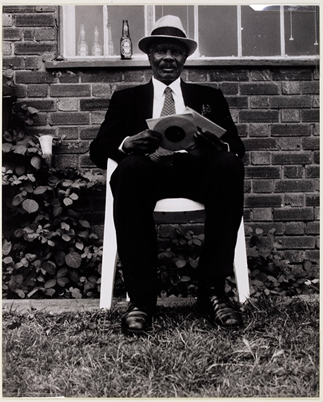 'Vin in Chair', photograph, by Charlie Phillips, 2002England . Museum no. E.263-2011. © Charlie Phillips/ Victoria and Albert Museum, London. Supported by the National Lottery through the Heritage Lottery Fund 