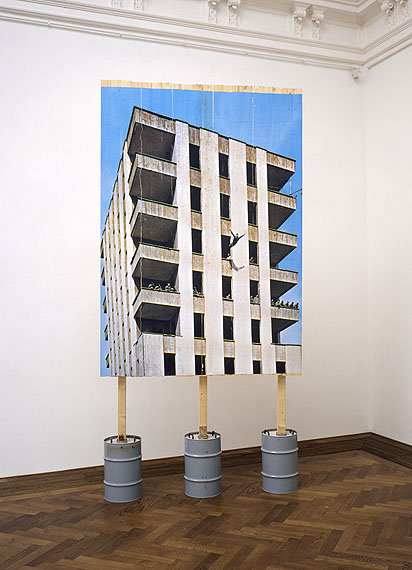Stefan BurgerLeap into the void under the supervision of a committee of experts, 2006Inkjet-print on wooden wall, concrete, metal drums, 400 x 200 x 80 cm© Stefan Burger