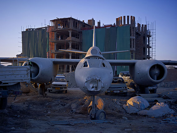 A dumping ground for an abandoned Russian-era bomber that has now been incorporated into the car park of ‘Shamshad TV’, a new media company supported heavily by American money. Kabul, 201040x53