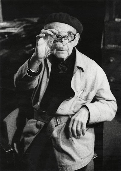 © Arnold Crane, Man Ray with his magnifying glass "verre Laurent" in his Studio in Paris Paris, 1969 - 1974