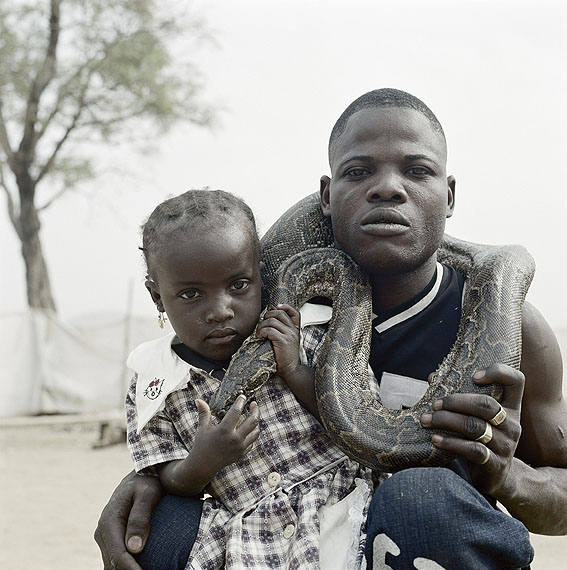 Pieter Hugo, Mummy Ahmadu and a snake charmer with a rock python, Abuja, Nigeria, 2005 From the series The Hyena & Other Men© Courtesy of Stevenson Gallery, Cape Town / Yossi Milo, New York
