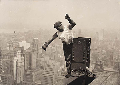 Lot 111: Lewis W. Hine, Empire State Building, worker signaling on high beam, silver print, 1930. Estimate: $10,000 to $15,000. 