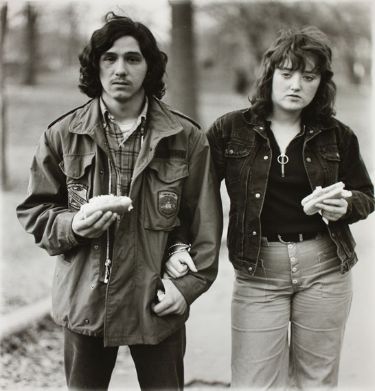 Diane Arbus A Young Man and His Girlfriend with Hot Dogs in the Park, N.Y.C., 1971 Gelatin silver print printed later by Neil SelkirkEdition of 7515 x 14.5 in. Est. 8,000–12,000 USD