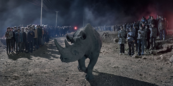 NICK BRANDTRiver of People with Rhino2018This Empty World42” x 90.7”Archival Pigment PrintNick Brandt courtesy of Atlas Gallery