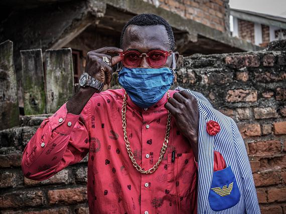 Bukavu, DRC, May 2020. Anglebert Maurice Kakuja, 29, a Sapeur, or Congolese dandy, shows off his fashion sense while wearing a homemade mask in the eastern Congolese city of Bukavu this week. Sapeurs take their name from the acronym for their group: SAPE, meaning Société des Ambianceurs et des Personnes Élégantes, or "elegant persons who create ambience". © Raissa Karama Rwizibuka for Fondation Carmignac