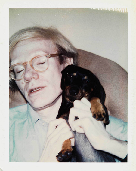 Andy Warhol, (Andy Warhol and Archie), 1973, from Family Album.  Dye diffusion transfer print (Polaroid):  sheet, 4 1/4 × 3 3/8 in. (10.8 × 8.6 cm);  image, 3 3/4 × 2 7/8 in. (9.5 × 7.3 cm).  Whitney Museum of American Art, New York;  gift of The Andy Warhol Foundation for the Visual Arts, Inc. 2014.29.536.  © 2026 The Andy Warhol Foundation for the Visual Arts, Inc. /  Licensed by Artists Rights Society (ARS), New York