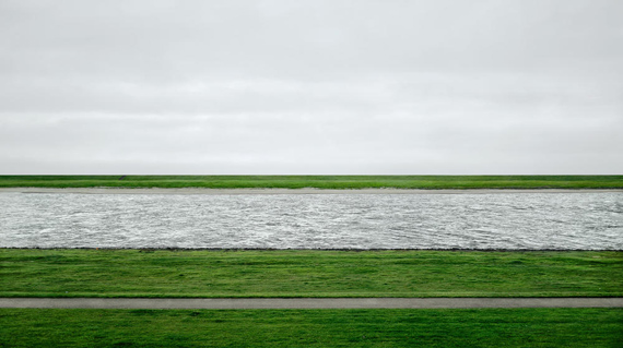 ANDREAS GURSKY (B. 1955) Rhein II signed 'Andreas Gursky' (on a paper label affixed to the backing board) chromogenic color print face-mounted to Plexiglas image: 73 x 143 in. (185.4 x 363.5 cm.)overall: 81 x 151a x 2 in. (207 x 385.5 x 6.2 cm.)Executed in 1999. This work is number one from an edition of six.© ANDREAS GURSKY, COURTESY OF CHRISTIE'S