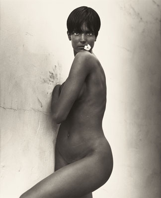 HERB RITTS (American, 1952-2002)Stephanie with Flower, 1989Gelatin silver, 1989Paper: 19-3/4 x 16 inches (50.2 x 40.6 cm)Image: 18-1/4 x 15 inches (46.35 x 38.1 cm)Edition: 12/25Recto: blind stamped (c) Herb RittsVerso: signed, titled, dated, and numbered in pencilState: hinged at top with archival tape to mat and framed